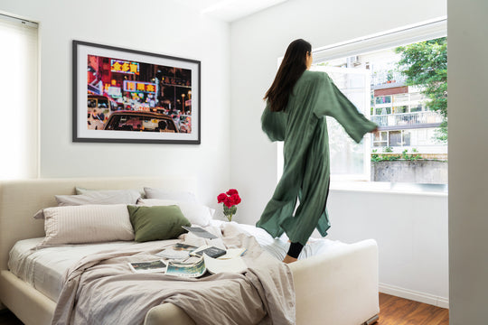 Vivienne Tang jumping in front of bedroom art on the wall by Vivien Liu